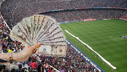 sports betting concept, holding US banknotes on a sport stadium background